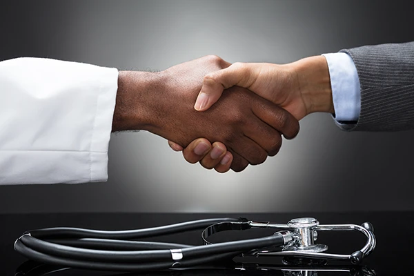 Doctor and clinical trial sponsor shaking hands