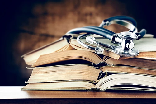 Stethoscope on top of medical books